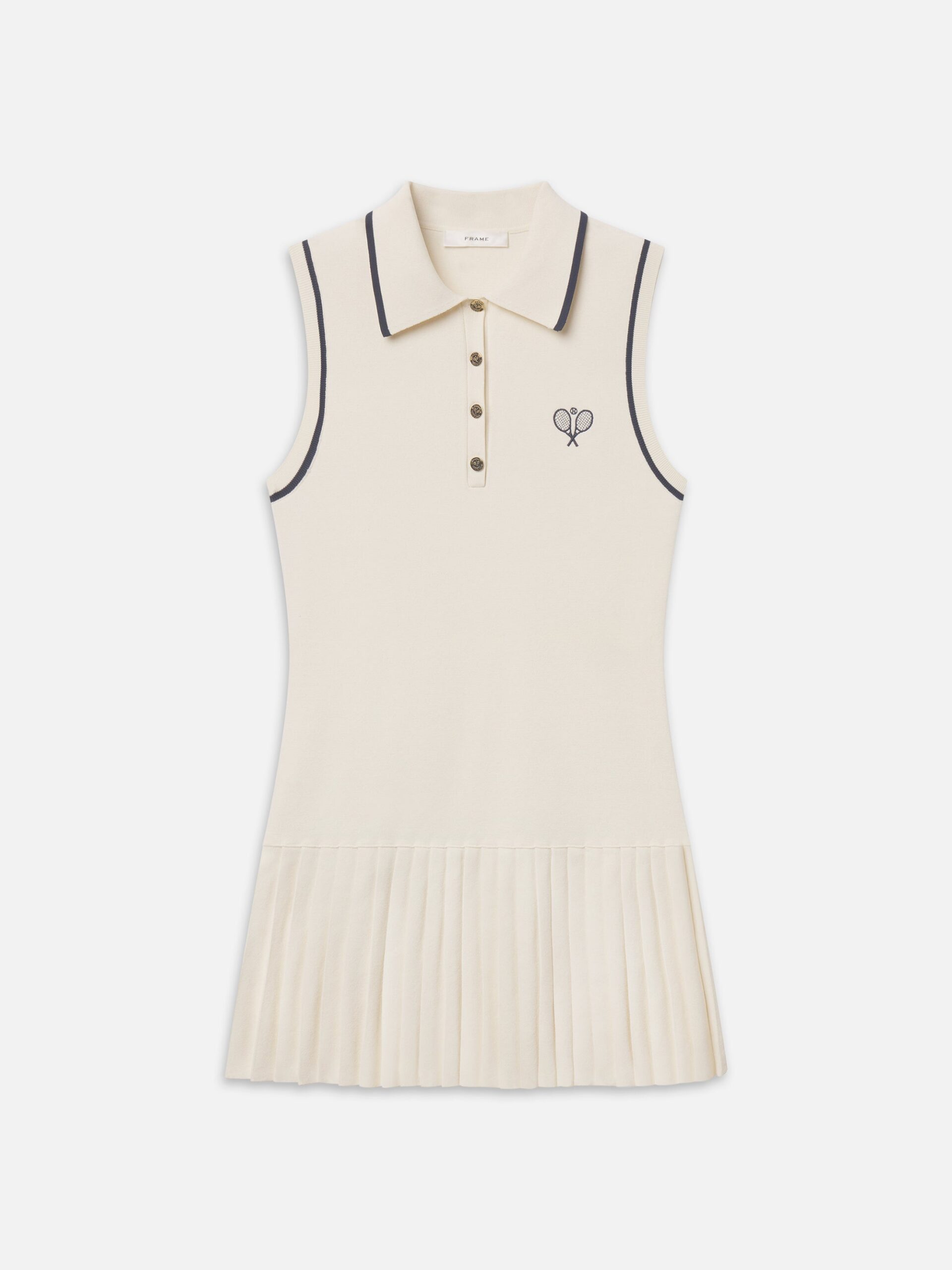 Original FRAME product photograph: cream sleeveless pleated tennis mini dress with navy piping, polo collar and crossed-racquet embroidery