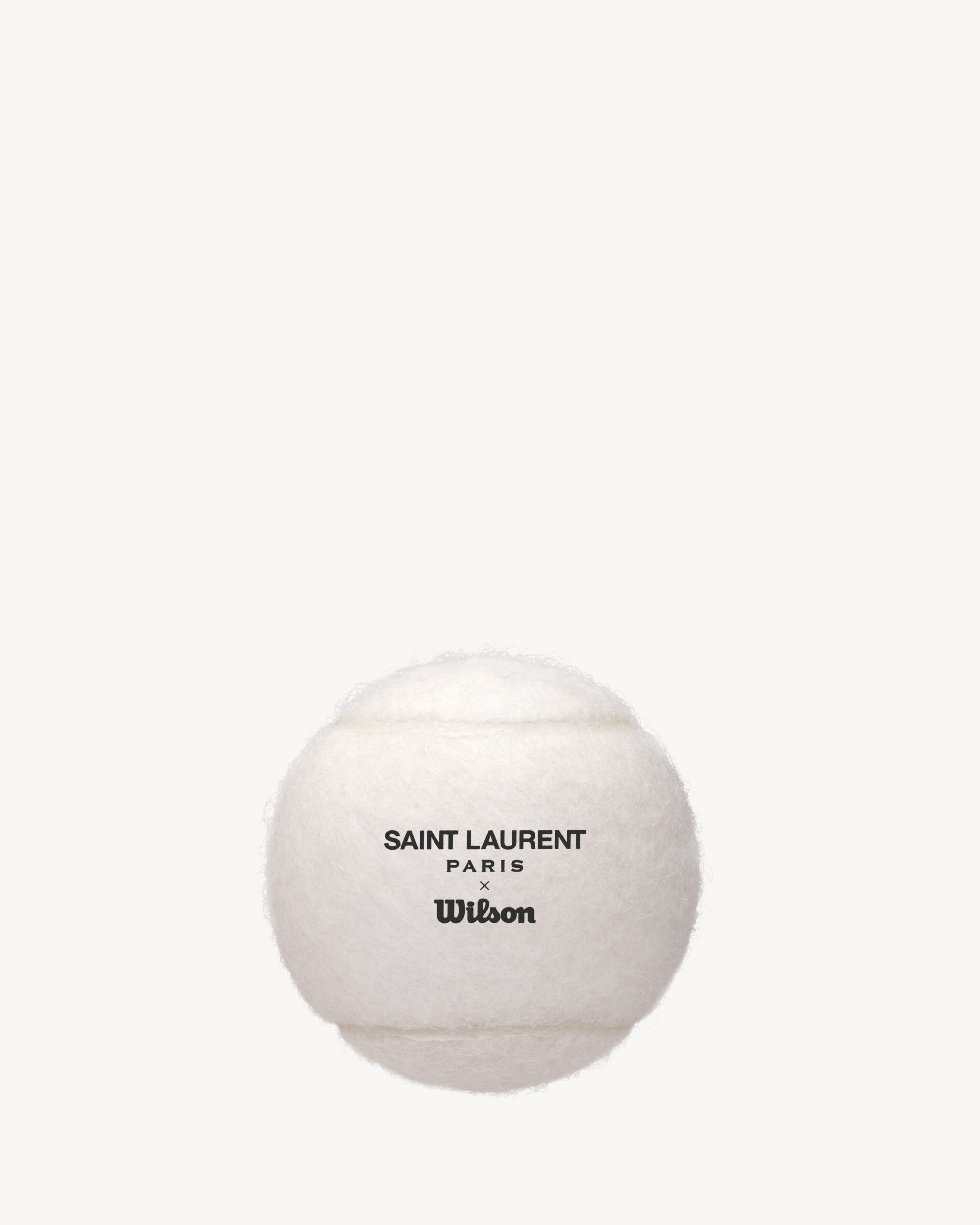Original Saint Laurent product photograph: white Wilson tennis ball with Saint Laurent Paris x Wilson lettering